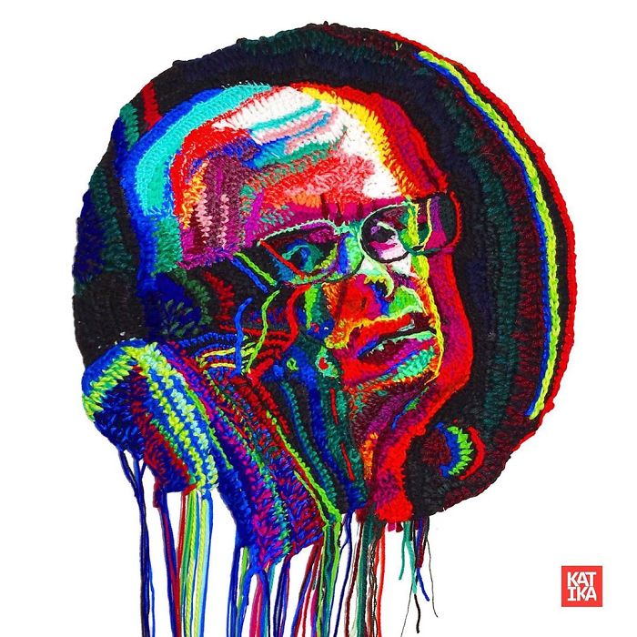 Vibrant crochet portrait with multicolored yarns creating a detailed artistic face showing deep expression.