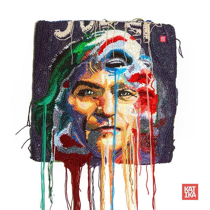 Crochet artist portrait featuring a colorful face design with dripping yarn threads and detailed textures.