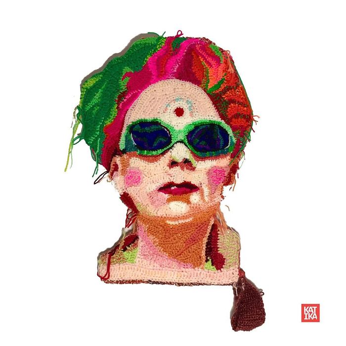 Crochet artist portrait featuring colorful yarn work of a person wearing green sunglasses and vibrant headwear.