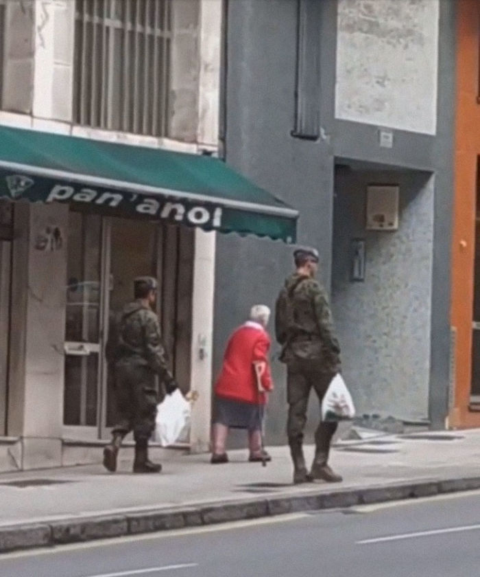 Spanish Soldiers Helping An Elderly Woman During Quarentine