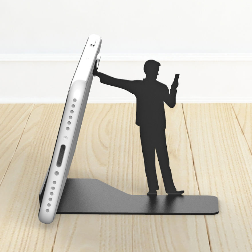 I Designed A Humorous Cell Phone Stand With Human Figures Holding Your Phone, But In Fact They’re Mostly Busy With Their Own Cell Phone!