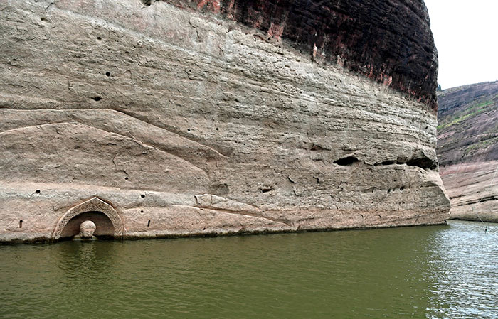 After A Construction Company Caused A Local Reservoir Level To Sink 10 Feet, A 600-Year-Old Buddha Carving Was Found