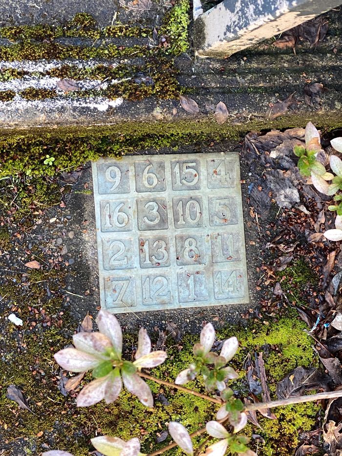 Plaque With Numbers Inscribed On It. Found On The Sidewalk Outside A Building At My University