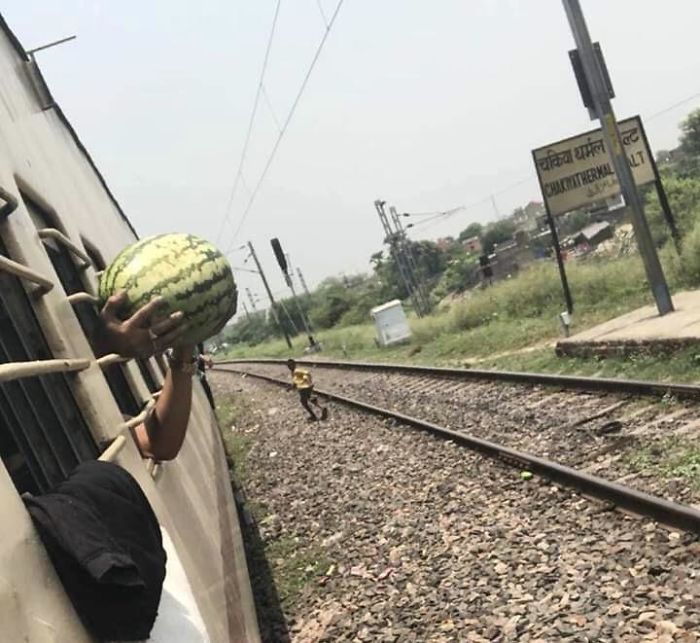 A Guy Purchased A Watermelon During A Train Stop And Didn’t Realize It Didn’t Fit Through The Bars