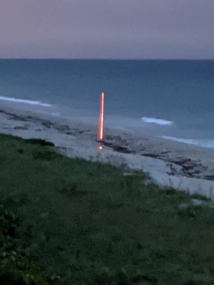 Weird Luminescent Red Thing On The Beach In A Lightning Storm