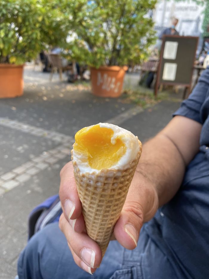 I Ate Coconut And Mango Ice Cream That Looks Like A Half-Eaten Poached Egg On A Waffle Cone
