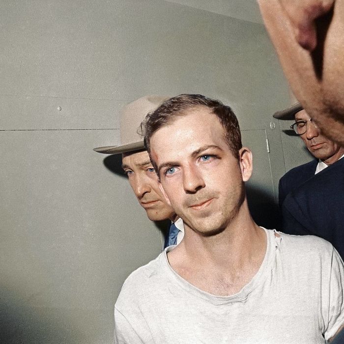 Lee Harvey Oswald Being Led Down The Dallas Police Headquarters Basement On November 23rd, 1963 - A Day Before His Murder - To Face Further Questioning In Regards To His Involvement In The Assassination Of President John F. Kennedy.
