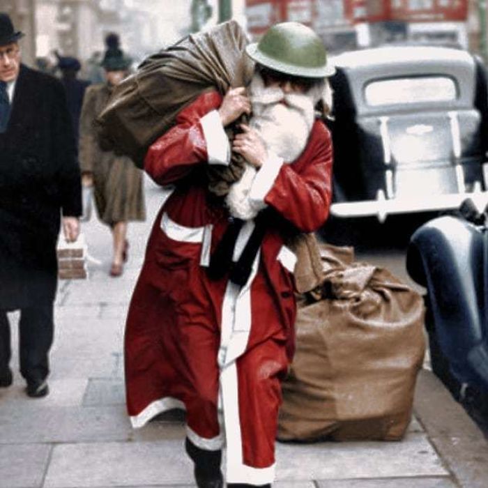 Father Christmas Wearing A Tin Helmet Walks Along Regent Street, London, With A Bag Full Of Presents - From Life Magazine, December 23, 1940
