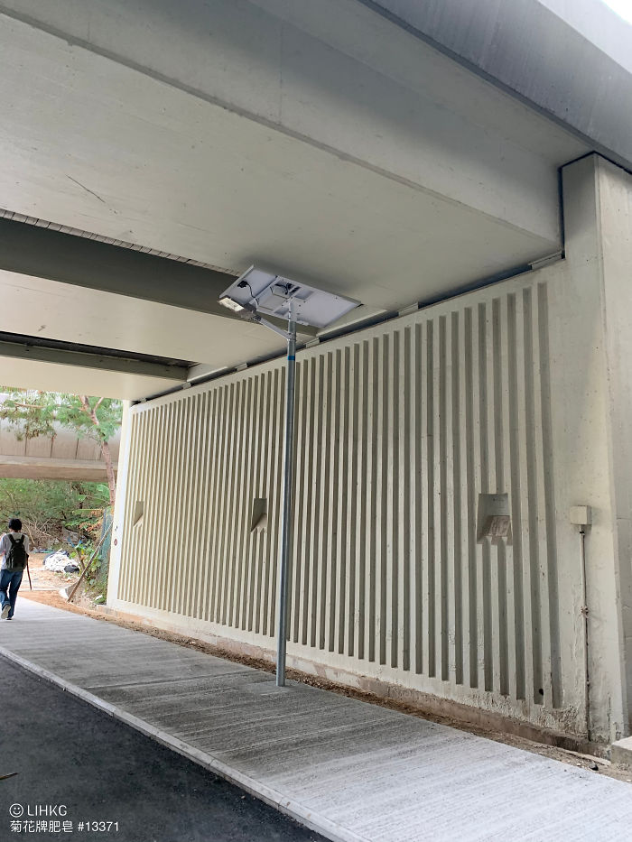 A Solar-Powered Streetlight Under A Bridge In Hong Kong
