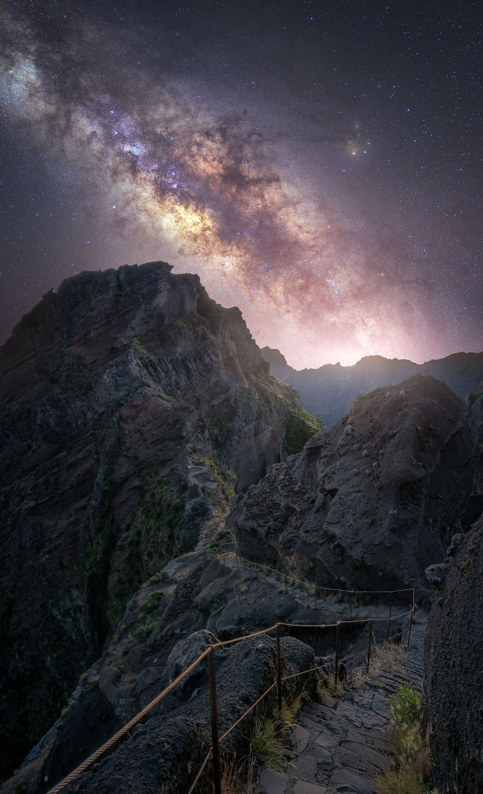 Night sky filled with stars and the Milky Way over rocky mountain trails in Madeira during a magical trip.