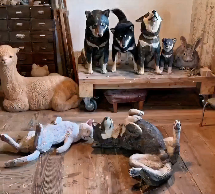 Cute Video Shows Dog Trying To Blend In Between Animal Sculptures