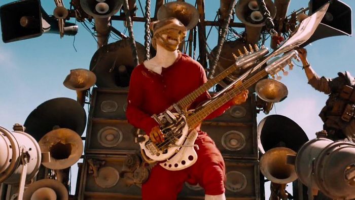 In Mad Max: Fury Road (2015), There Is A Character Called The Doof Warrior That Rides A Van Made Out Of Amps While Playing An Electric Guitar That Shoots Fire. I Don’t Have Anything Else To Add But Remember That S*it? That Movie Fu**in Ruled, Let’s Watch It