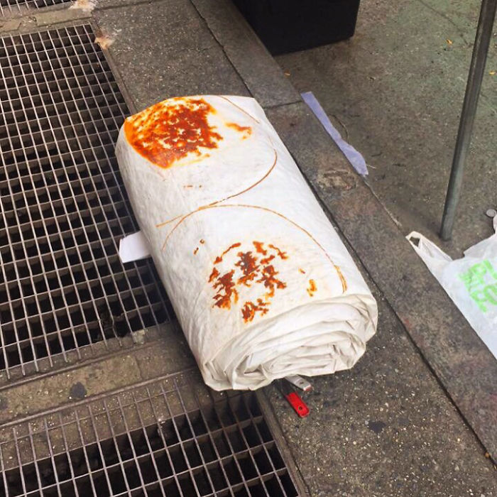 Can't Tell If Rust Stained Tarp Or World's Largest Burrito Just Casually Chilling On The Sidewalk