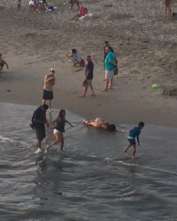 National Geographic Photographer Captures Beached Influencer As People Just Walk Around Like Nothing Is Wrong. So Sad!
