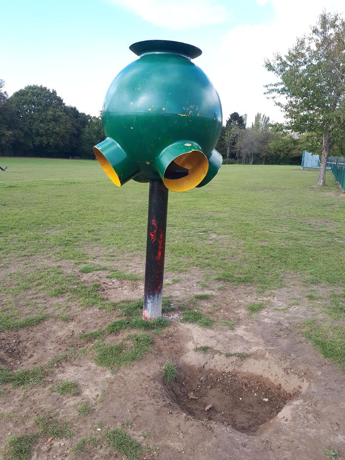 On It's Own In A British Park, Tall As A Person And Hollow Inside. Made Of Metal And Looks Like Something Used To Be Below Each Of The Four "Exits"