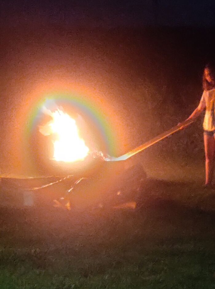 Took A Picture Of My Daughter Lighting A Campfire - It Appears She Is Summoning The Spirit Of A Unicorn