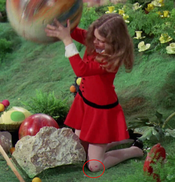 In Charlie And The Chocolate Factory (1971), Veruca Salt Has A Bloody Knee In The Chocolate Room Scene. Her Actress, Julie Dawn Cole, Cut It On The Sharp Rock While Filming The "Egg Breaking" Scene. She Still Has A Scar From The Injury Today