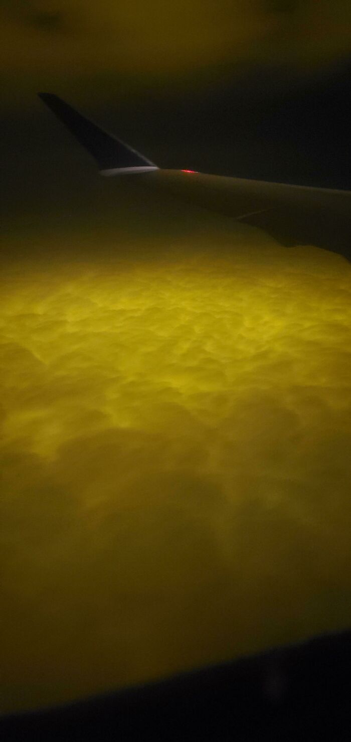 My Boyfriend And I Were Traveling Sunday Evening (10/25) And We Flew Over Clouds That Were Glowing Orange. Photo Details Suggest That It Was Somewhere Over Kingsville, On, Canada. Any Idea What Caused This?