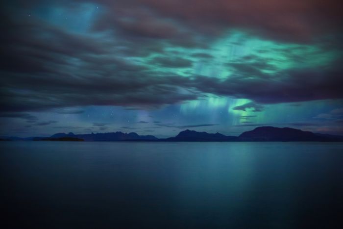 Aurora Borealis In Between The Clouds
