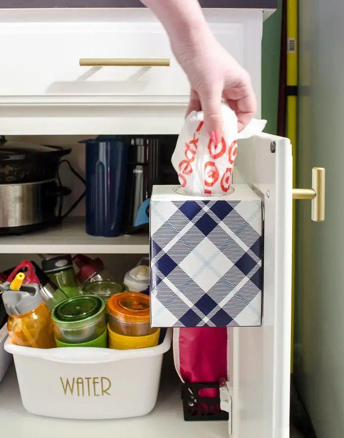 Attach An Empty Tissue Box To The Inside Of A Kitchen Cabinet For Easy-To-Grab Storage
