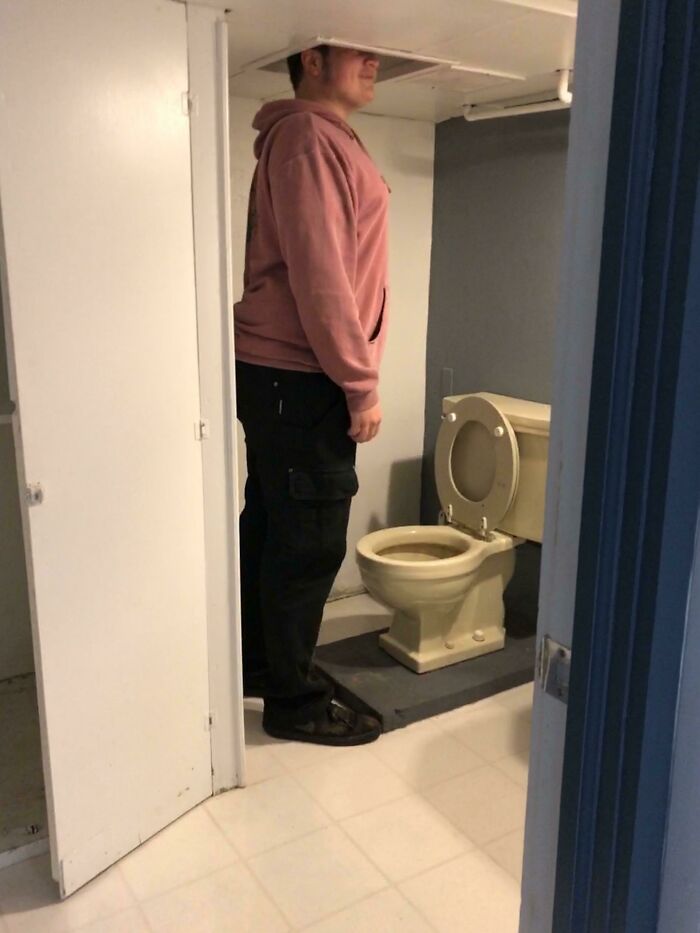 This Bathroom In My Dad's New House. I’m 6’1”. The Room Is So Short They Had To Cut Holes In The Ceiling Over The Toilet And Sink So You Can Stand Up