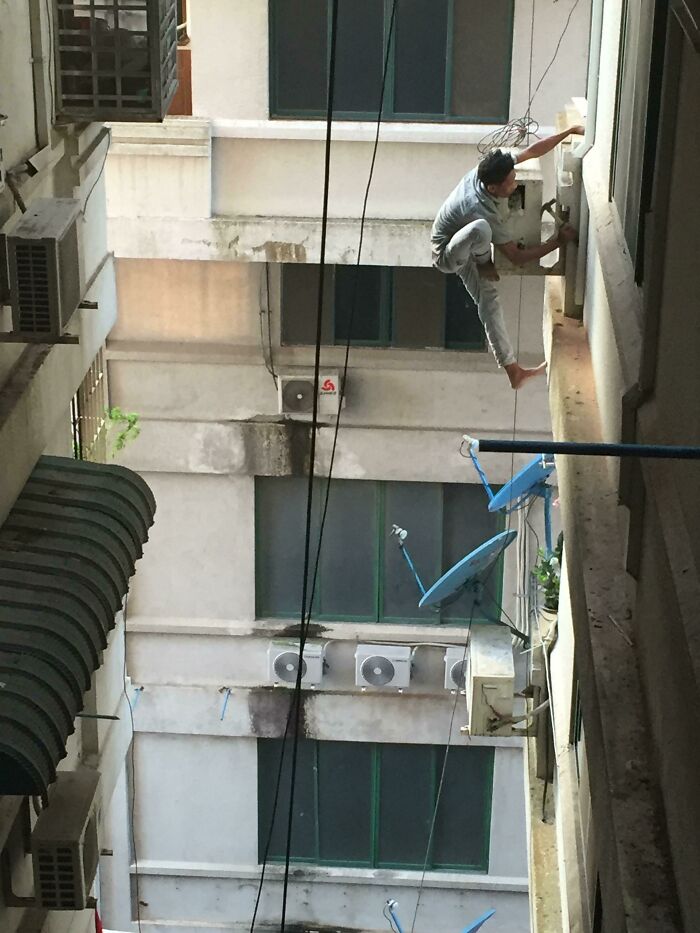 No Such Thing As ‘Health And Safety’ In Myanmar - This Dude’s Repairing An Air Conditioner On The 22nd Floor. As You Do
