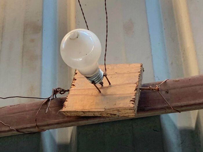 This Lightbulb Is Held Up By Three Nails And Loose Wiring