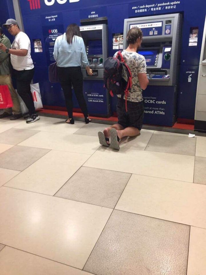 Just A Tall Tourist Using An ATM In South East Asia..