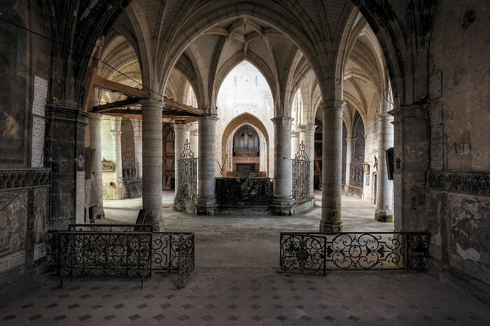 Interior of an abandoned church in Europe featuring gothic arches and aged stone columns discovered during extensive travel.