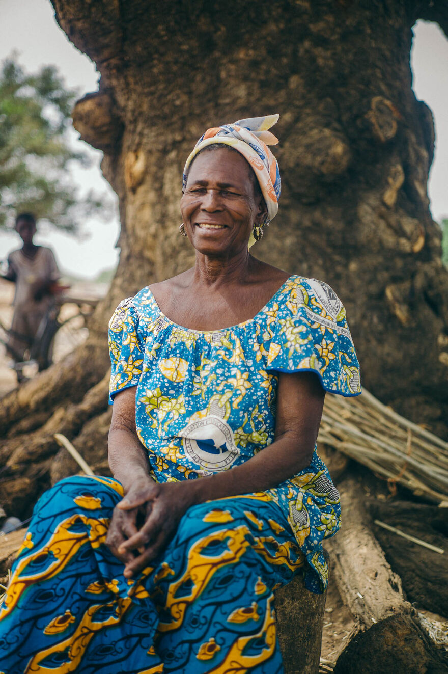 Portrait Of An Elderly Woman Sitting Under A Baobab Tree, Fada N'Gourma, Burkina Faso