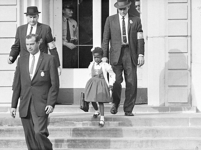 U.S. Marshalls Escorting The Extremely Brave Ruby Bridges, 6 Years Old, To School In 1960. This Courageous Young Girl Is Known For Being The First African American Child To Attend An All-White Elementary School In The South