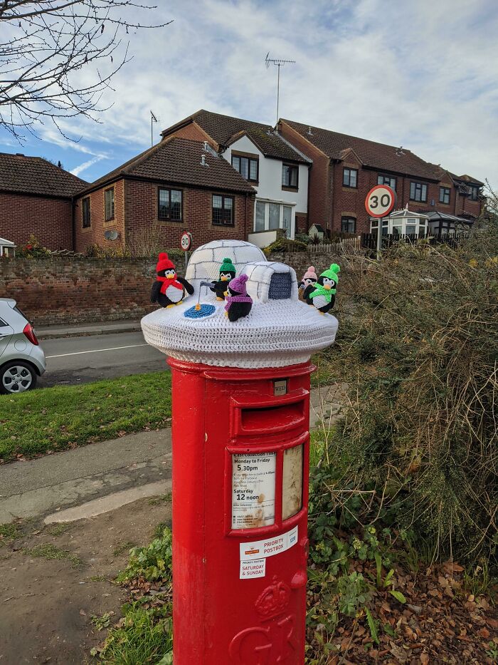 Every Year On December 1st Someone Puts A Knitted Hat On Top Of The Post Box At The End Of My Road. This Year's Is The Best So Far