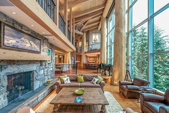 Living Area With A Glass Wall And Cedar-Log Posts And Beams In This Ski Retreat Located In Whistler, British Columbia