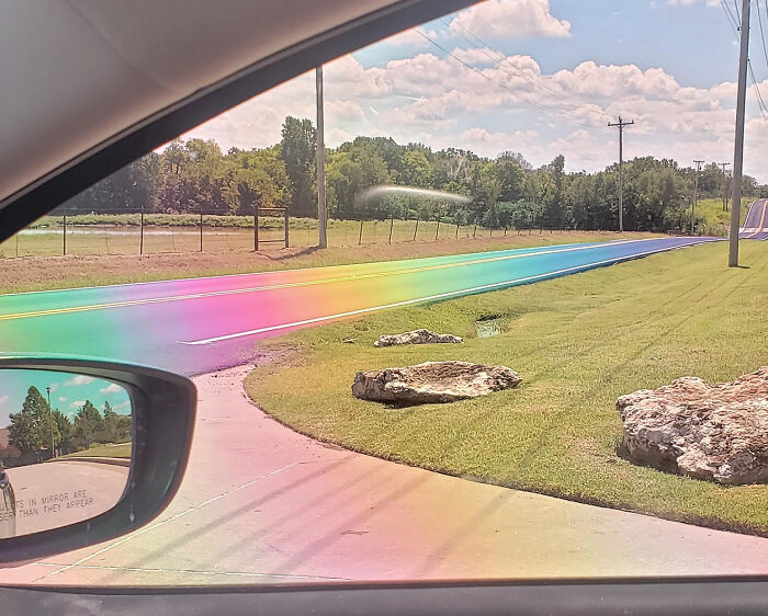 El sol cayó justo sobre este asfalto recién pavimentado e hizo un camino de arco iris en la vida real a través de lentes polarizadas