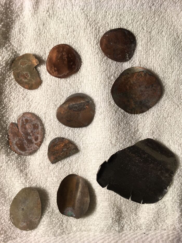 Collection Of Pennies Left On Railroad Tracks And Squashed Flat By The Train.
