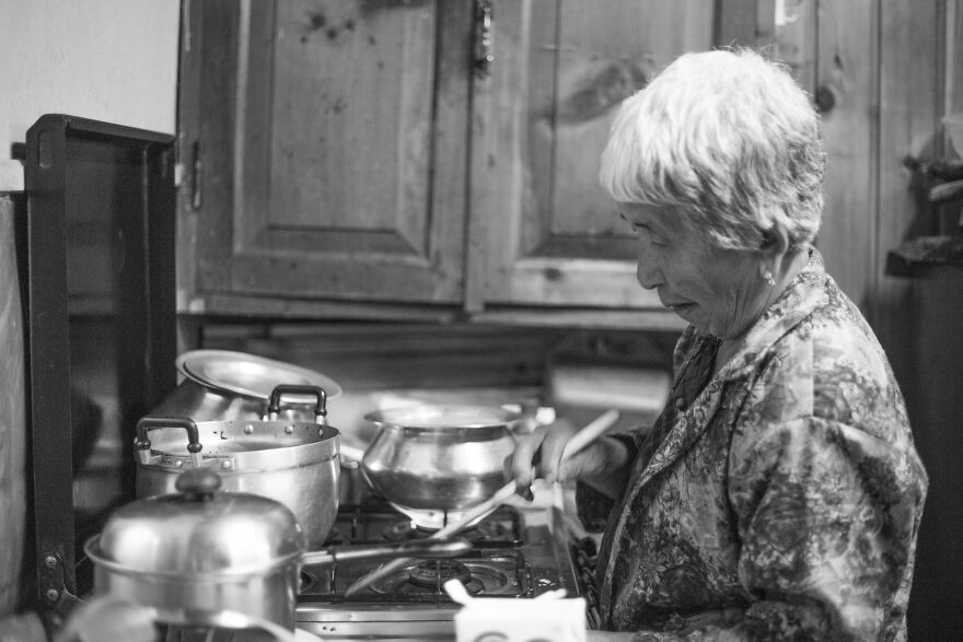 The Appearance Of An Elderly Woman Standing In The Kitchen.