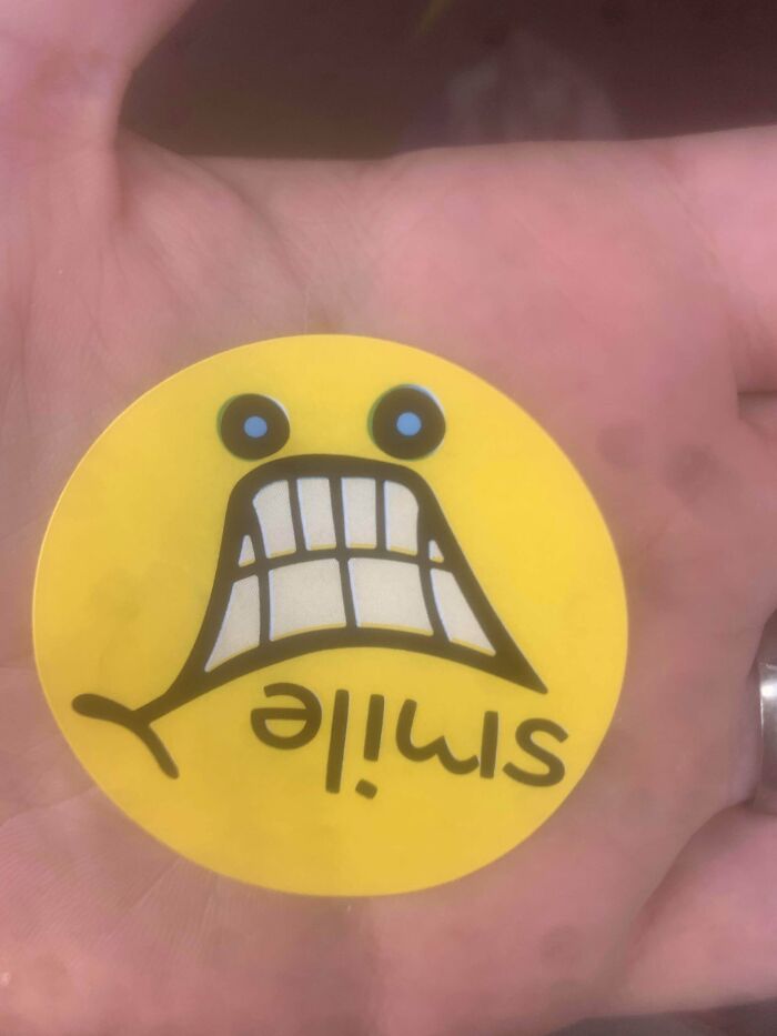 A Sticker From The Grocery Store. It Says “Smile,” And Tries To Use A Distorted Shopping Cart To Make A Smile. However, The Wheels On The Cart Pull The Brainwaves Into Thinking The Face Is Upside Down. Coincidentally, This Is The Face I Made When I Saw It