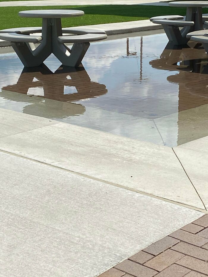 School Does Some Renovations. New Outside Area Has The Tables In A Lower Section Surrounded By A Step Up Of Pavement. Guess What Happened When It Rained Two Days Ago
