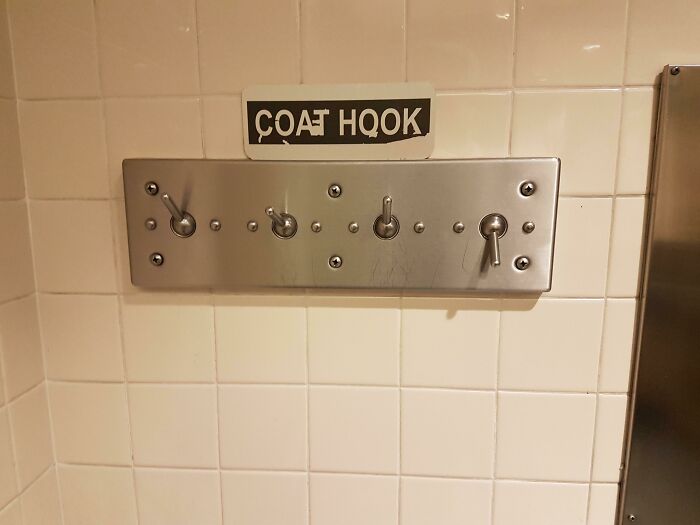 This 'Coat Hook' At The Airport Bathroom That Hinges And Drops Everything On The Floor