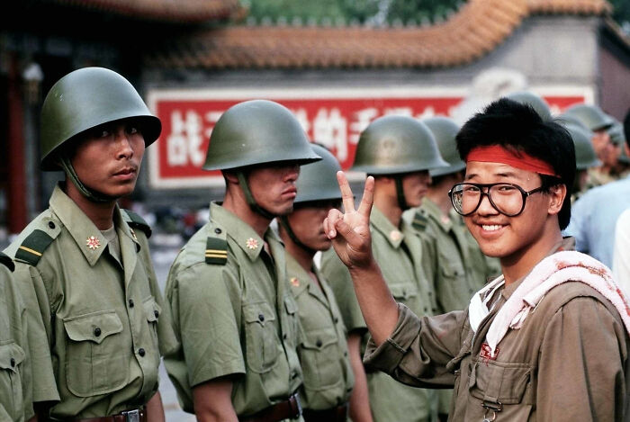 A Student Protester Gives The V For Victory Sign In Front Of Chinese Soldiers Of The Pla. Tiananmen Square, 1 June 1989. Photo Taken By Peter Charlesworth