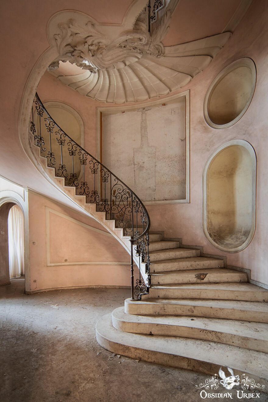 A Shell-Like Decoration Fans Out From The Top Of The Staircase Inside This Derelict House