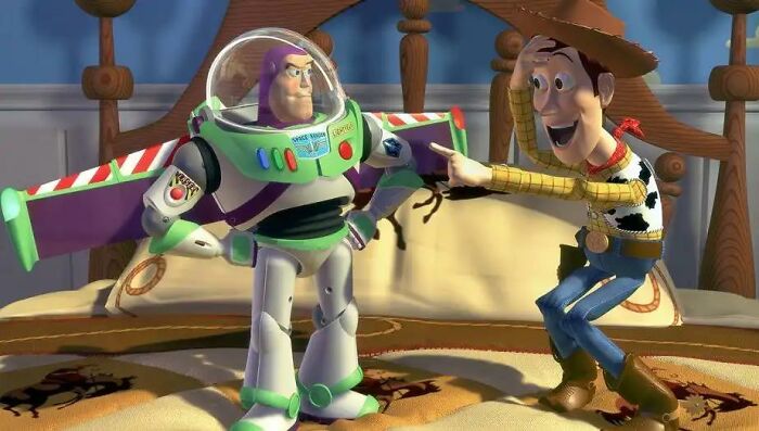 If Buzz Lightyear Doesn't Think He's A Toy, Why Does He Freeze Up When Humans Are Around In Toy Story (1995)?