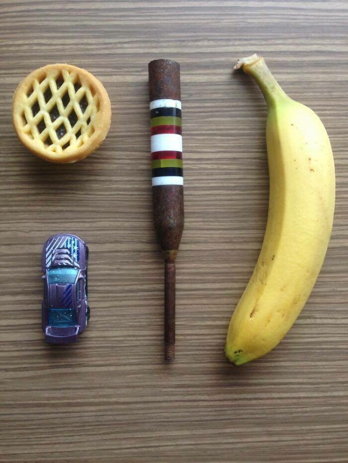 Found This Metal Object In Auckland, New Zealand. Banana, Hot Wheels Car And Fruit Pie For Scale! Metal (Brass?) With Screw Thread At The Bottom And Coloured Plastic Rings Around Shaft, Some Opaque, Some Transparent. Found On The Shoreline At The Ōtuataua Stonefields Reserve, Near The Airport