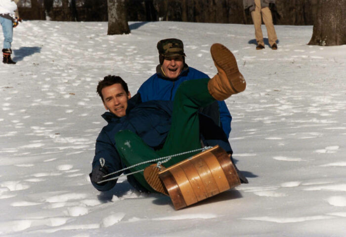 George H.w. Bush Takes A Toboggan Ride With Arnold Schwarzenegger At Camp David. 1991