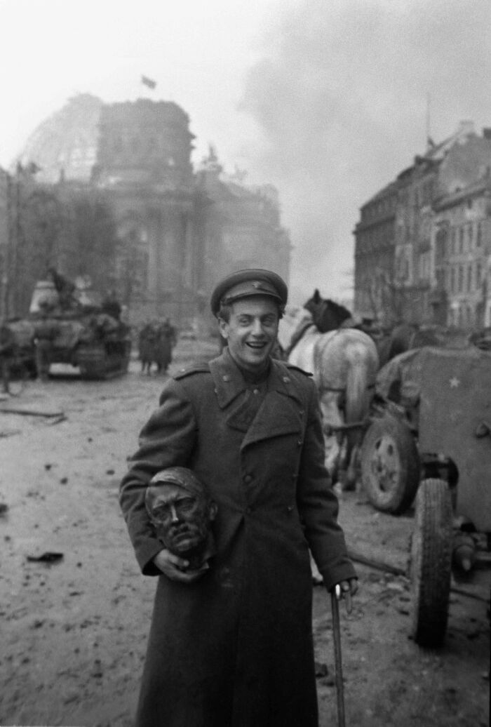 Soviet Soldier Carrying The Head Of A Statue Of Hitler, Berlin 1945