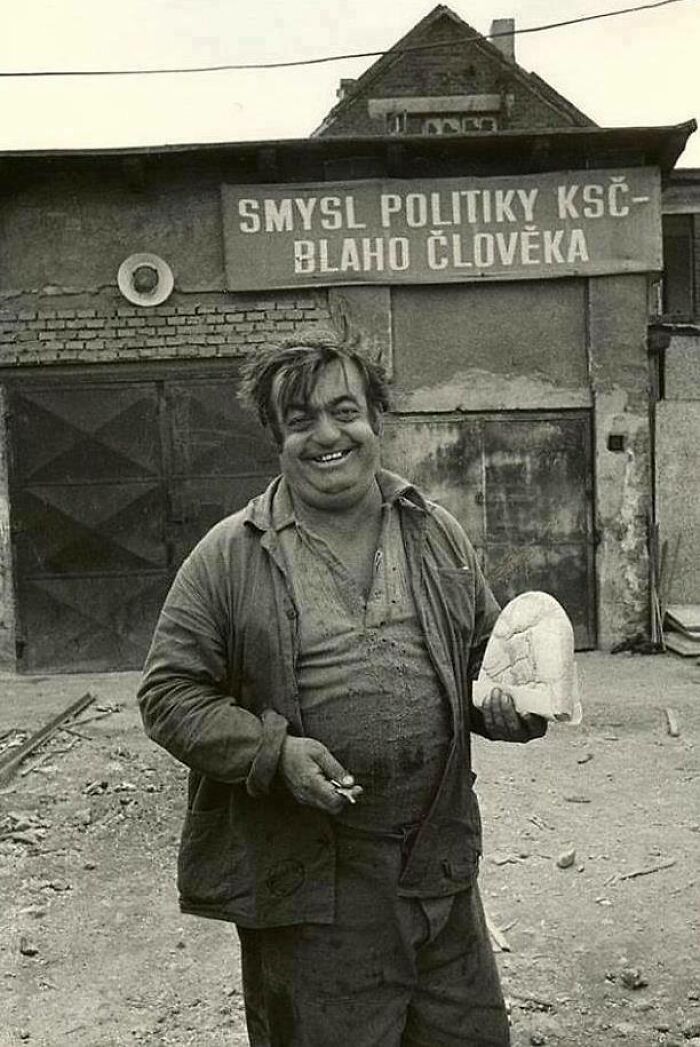 Czechoslovak Man Posing With Half Loaf Of Bread In Front Of Banner "The Meaning Of The Policy Of The Communist Party Of Czechoslovakia - Paradise For Humans" Communist Czechoslovakia, Probably 1960