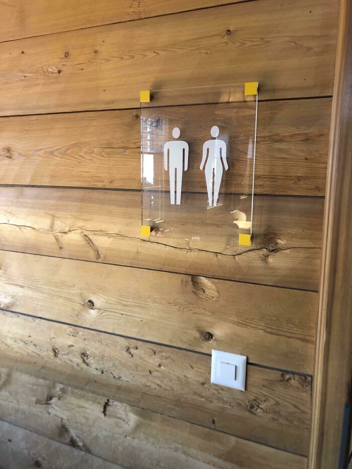 The Female On This Restroom Sign Isn’t Wearing A Dress