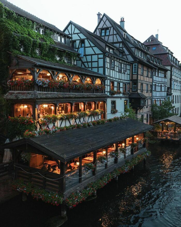 Restaurant On The River Ill Flowing Through The Historic Petite France Quarter Of Strasbourg, France