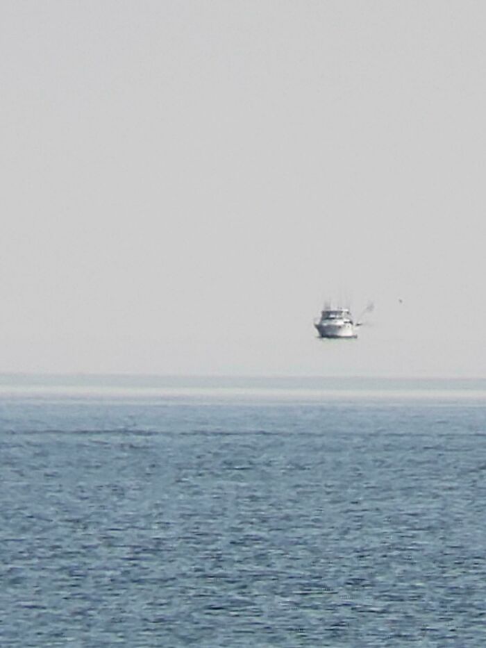 Mirage On Lake Ontario Makes Boat Look Like It's Flying