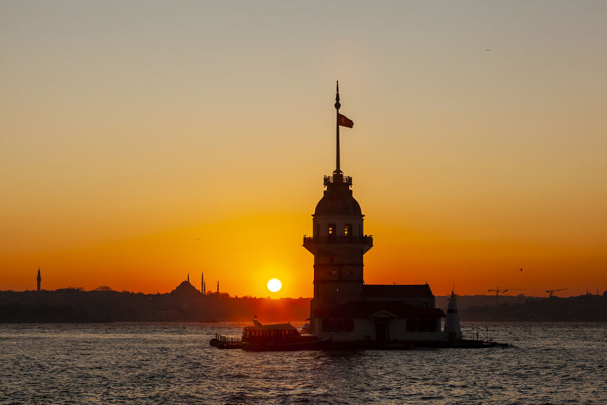Maiden Tower Photo Taken During Sunset From The Asian Side. In The Backdrop, You Can See The Old City Silhouette Where Hagia Sophia And Blue Mosque Are Located